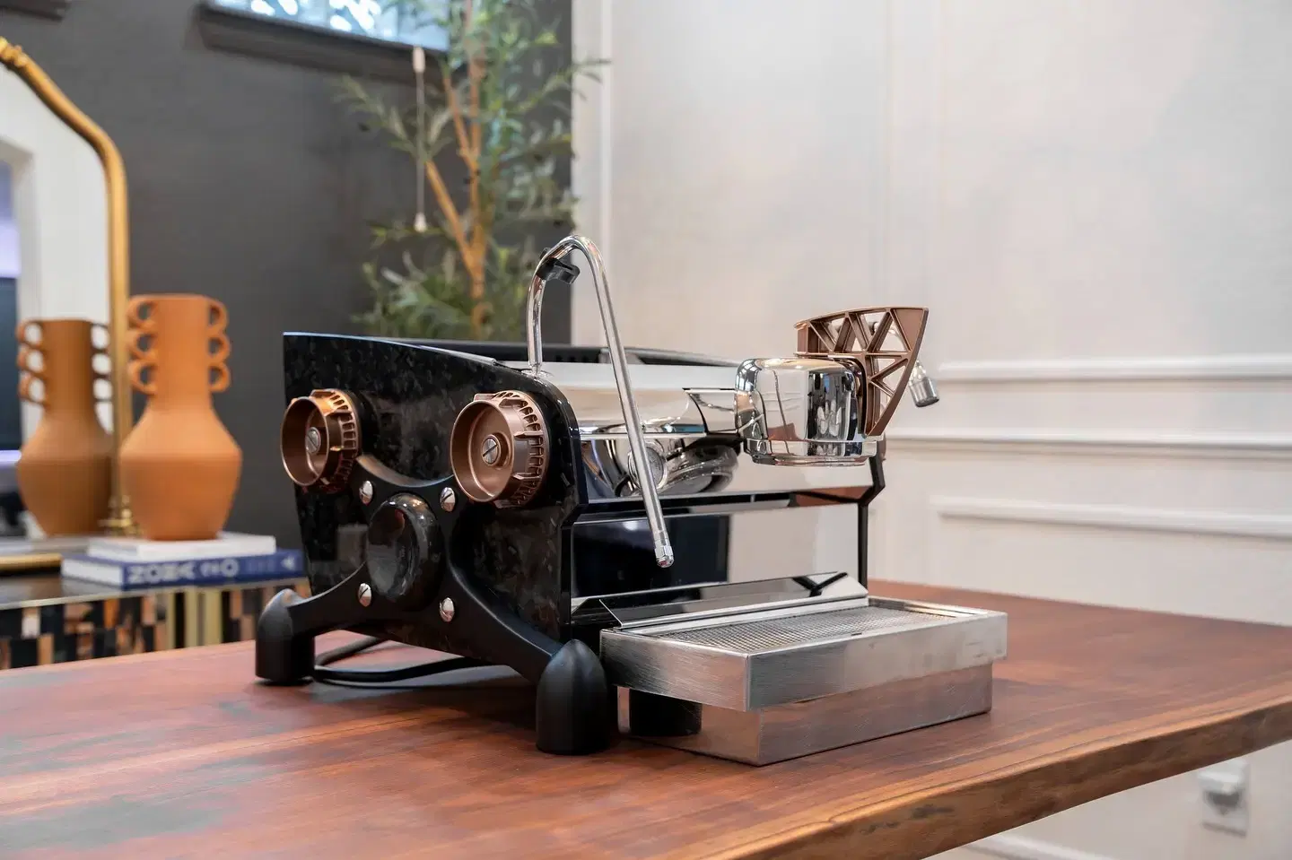 Slayer Espresso Single handcrafted espresso machine on a warm wooden bar countertop