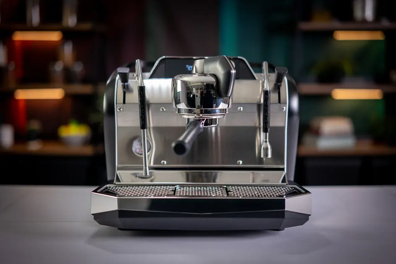 Slayer Steam Single single-group espresso machine on a café counter with dark background